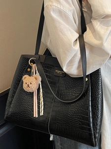Large black crocodile pattern tote bag with gold logo and plush bear pendant for women