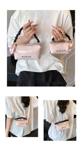 Détail du sac oreiller en cuir verni rose avec breloque cœur et poignées plissées