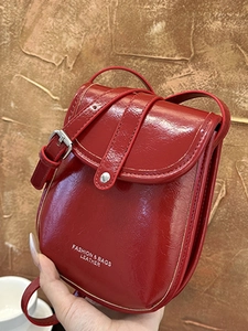 Red patent leather crossbody flap phone bag with adjustable silver buckle shoulder strap