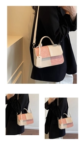 Detail showing color-block pink and beige handbag with top handle and strap