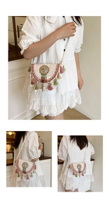 Detail view of Bohemian woven crossbody bag featuring colorful tassels and ethnic embroidery