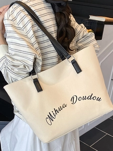 Grand sac cabas en toile avec poignées en cuir noir et imprimé de lettres sur blanc