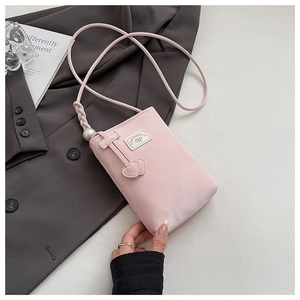 Detail of pink faux leather phone bag with heart charms, pearl accent and braided strap