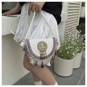 Detail of bohemian woven bag with purple tassels and colorful beaded round totem