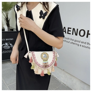 Detailed view of bohemian woven crossbody bag with colorful tassels and beaded mandala charm