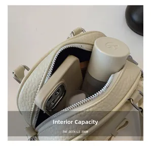 Macro view showing the internal capacity and textured leather of the chic shell bag