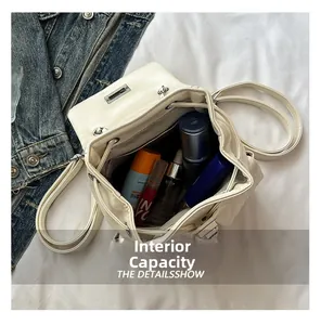 Top view of cream leather backpack showing spacious interior with skincare items
