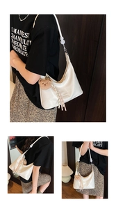 Detail view of white crocodile pattern shoulder bag with cute brown bear charm