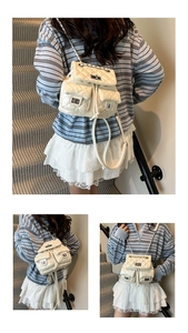 Detail of cream quilted mini backpack with chain straps and silver metallic locks