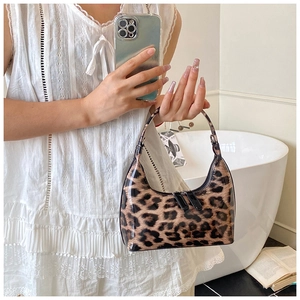 Detail of trendy leopard print hobo bag in glossy finish with sleek black zipper