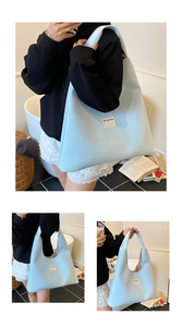 Detail view of the light blue velvet tote bag showing soft texture and shoulder strap