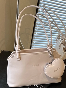Creamy chic underarm handbag for women with a heart-shaped charm and silver chain strap