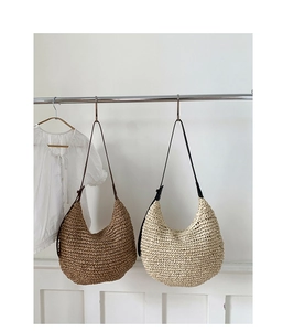 Detailed close-up of woven straw hobo bags in beige and brown with leather straps