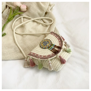 Detail of bohemian fringe crossbody bag with colorful beads and woven texture