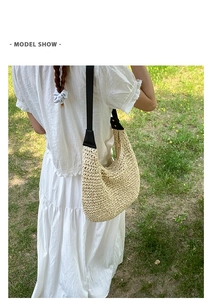 Detail of hand-woven straw tote with premium black leather shoulder strap and hardware
