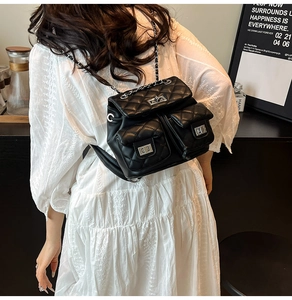 Fashionable black quilted mini backpack with silver chain straps and multiple pockets