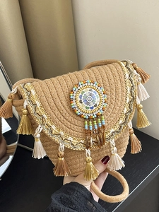 Bohemian straw shoulder bag with colorful tassels and ethnic floral weaving details
