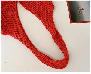 Close-up of red hollow knit shoulder strap showing intricate crochet texture and mesh