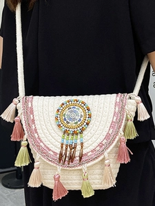 Bohemian woven crossbody bag with colorful tassels and ethnic beads for beach vacation