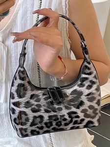 Leopard print faux leather crescent bag with chain detail and glossy animal texture