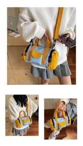 Detail of blue and yellow Boston bag showing the adjustable strap and zipper closure