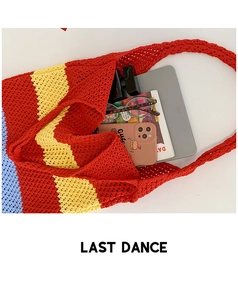 Detailed interior view of a large colorful striped crochet tote bag showing ample storage space