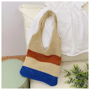 Close-up of a hollow-out knitted tote bag with multi-color patchwork for beach travel