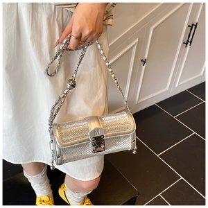 Detail showing silver metallic crossbody bag with chain strap and M-engraved buckle