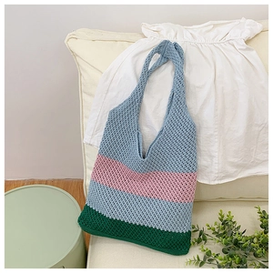 Close-up of colorful striped knit tote bag with handmade honeycomb crochet texture