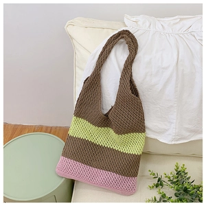 Close-up of handmade crochet tote bag with brown green and pink contrast stripes