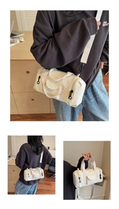 Detail view of cream Boston barrel bag showing adjustable straps and zipper pockets