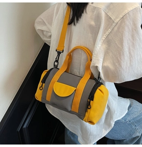 Detailed view of yellow and grey contrast Boston bag with adjustable shoulder strap