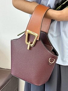 Elegante borsa a secchiello in pelle bordeaux con manico marrone e fibbia dorata