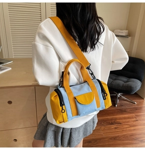 Detail of yellow and blue contrast canvas boston bag with adjustable wide shoulder strap