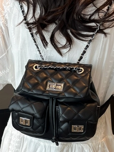 Chic quilted black leather backpack with silver hardware and chain straps shown on model