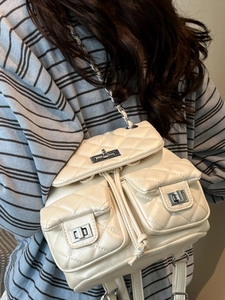 Chic beige quilted backpack with silver turn-lock pockets and chain straps for women