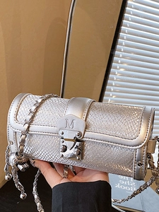 Silver snake pattern cylindrical chain bag with metal lock and M initial detail