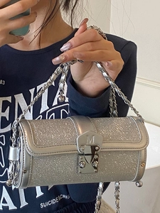 Silver glitter cylinder chain bag with metallic lock featuring decorative M engraving