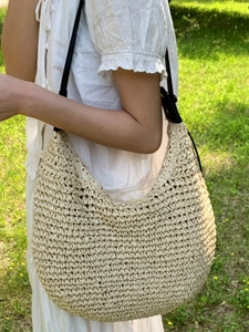 Large capacity woven beach hobo bag with black leather shoulder strap in natural beige