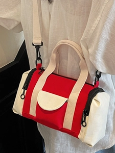 Red and cream canvas Boston cylinder bag with contrast colors and adjustable strap
