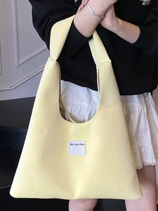 Minimalist yellow velvet underarm tote bag with wide strap and fashion logo label