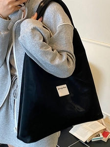 Minimalist large black tote bag for women with shoulder strap and stylish fabric patch