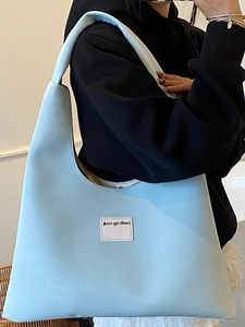 Minimalist light blue hobo bag with wide shoulder strap and spacious interior