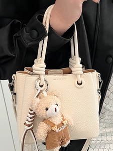 Chic off-white lychee texture bucket bag with bear charm and detachable shoulder strap