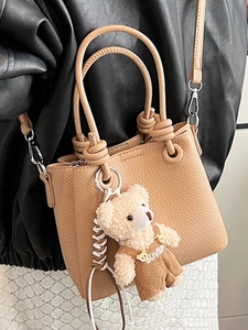 Litchi pattern bucket bag in light khaki with plush bear pendant and knot handle
