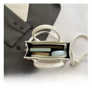 Top view of white crossbody bag interior showing spacious storage for daily essentials