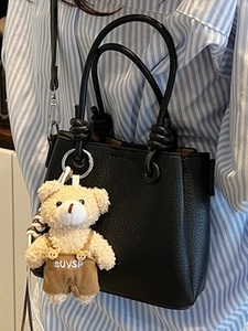 Minimalist black lychee texture bucket bag with cute bear charm and silver hardware