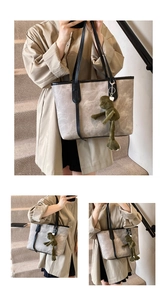 Detailed view of grey marble tote bag featuring a green plush frog charm accessory