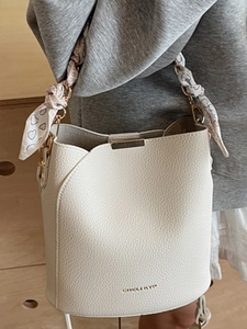 Minimalist white leather bucket bag with silk heart scarf and elegant metal logo detail