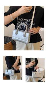 Detailed macro view of silver metallic mini square bag with handle and branding detail